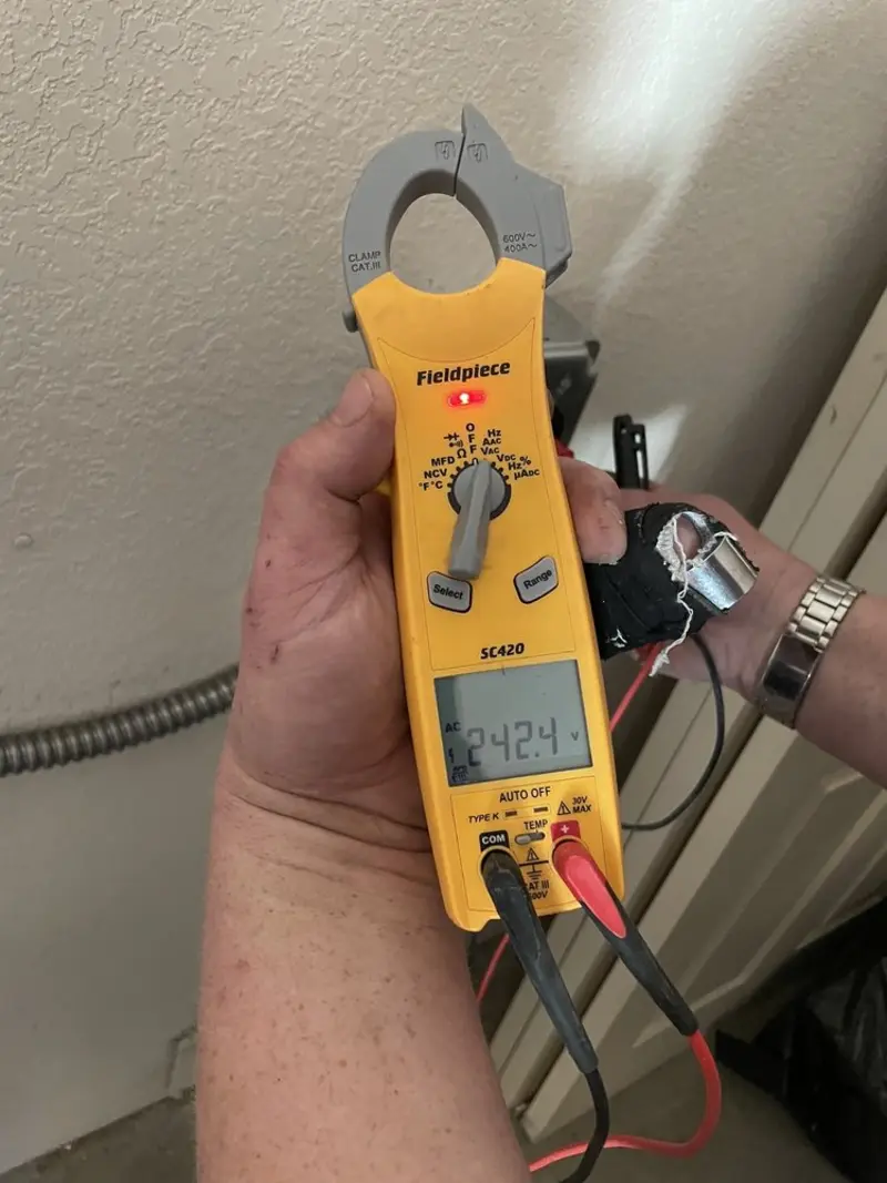 Voltage testing with clamp meter during Aluminum Wiring Replacement in Marvin